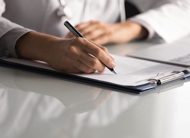 doctor taking notes for patient research