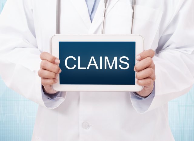 doctor holding a medical claims sign