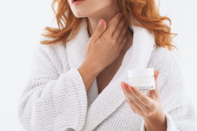 woman applying neck cream