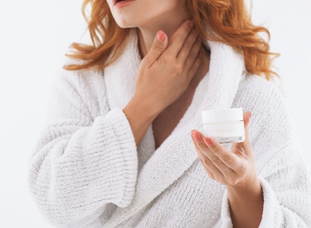 woman applying neck cream