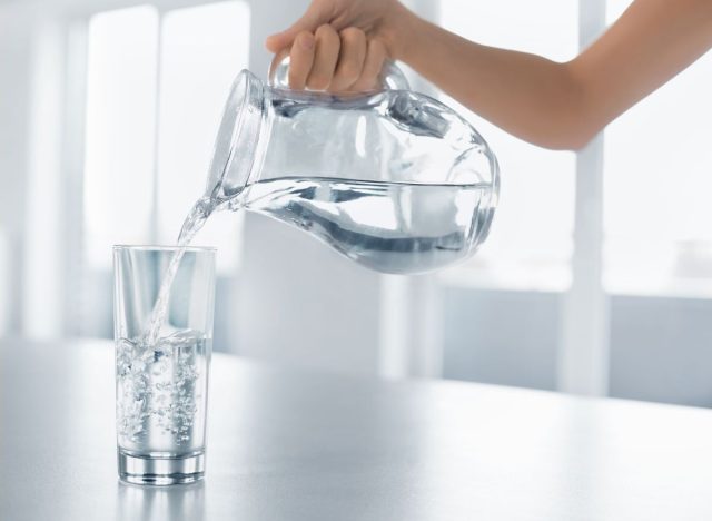 Pitcher into glass of water
