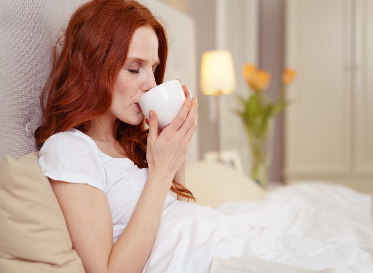 Woman Drinking in Bed