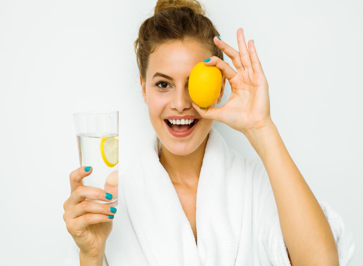 Woman with lemon and water