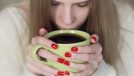 Woman with red nails Drinking Coffee