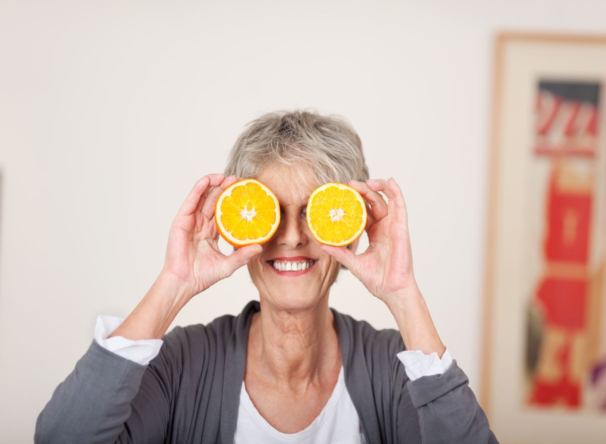 Woman holding oranges as eyes