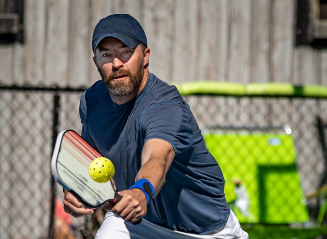 active man playing pickleball