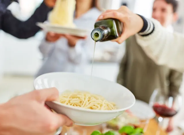 adding oil to pasta