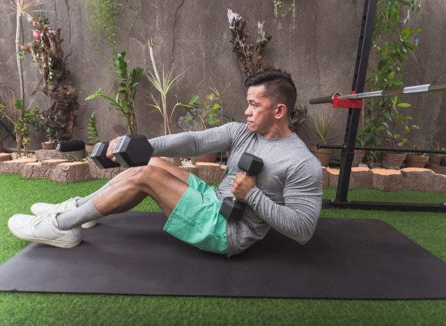 Man doing basic exercises with dumbbells to accelerate belly fat loss