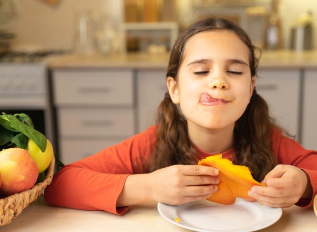 girl eating mango