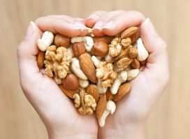 holding mixed nuts and forming heart shape