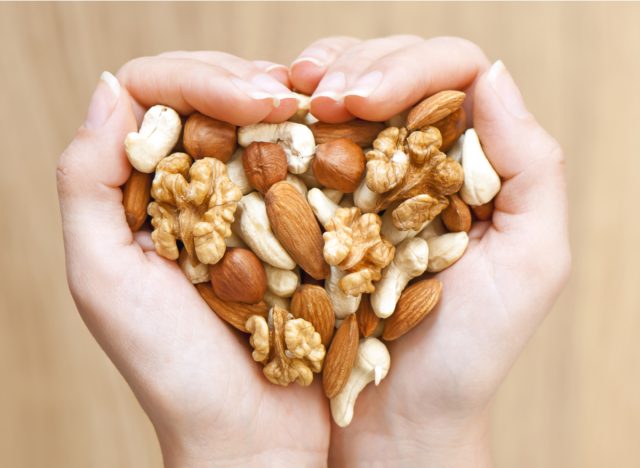 holding mixed nuts and forming a heart shape