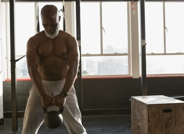 mature man demonstrating kettlebell deadlift to shrink your waistline