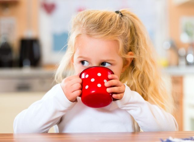 kid drinking from mug