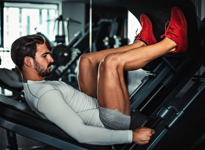 man doing leg press machine exercise to increase visceral fat burn
