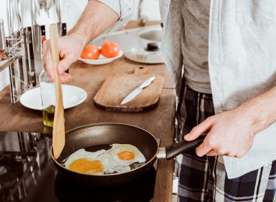 man cooking eggs