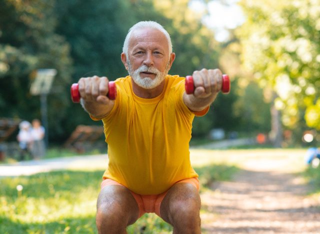 mature man doing dumbbell squat as part of leg-strengthening exercises for seniors