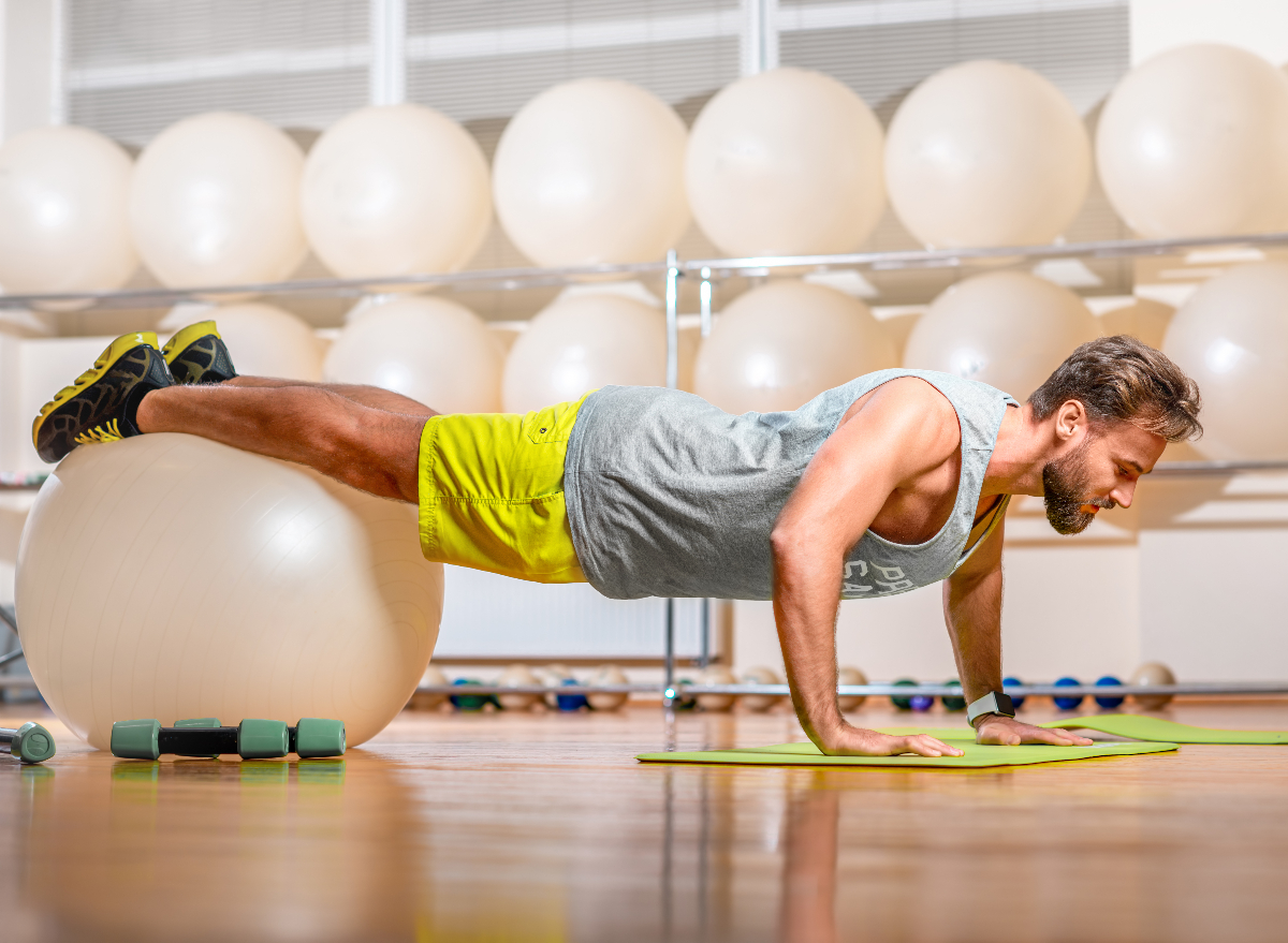 man performing stability ball exercises