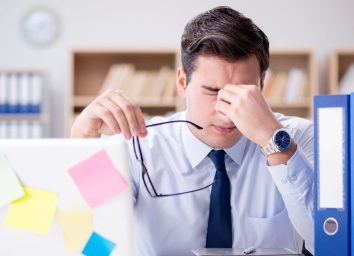 man stressed at work at his desk