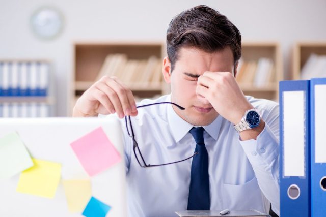 man stressed at work at his desk