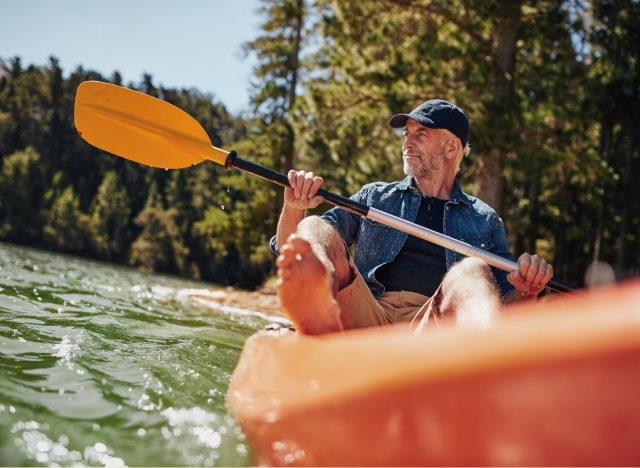 mature man rowing on sunny day, staying young and active
