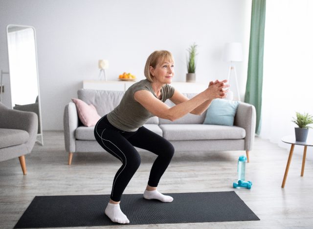 mature woman doing squat, demonstrating how to shrink your waistline