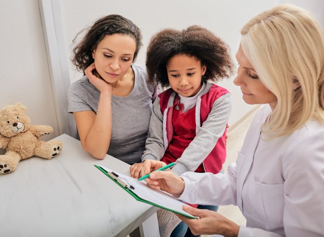 mother and young daughter talking with therapist about mental health