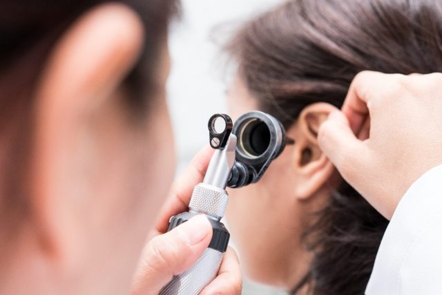 patient having hearing problems checked by doctor, early sign of parkinson's