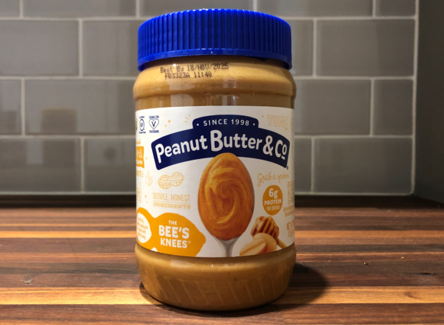 peanut butter and co jar on a table.