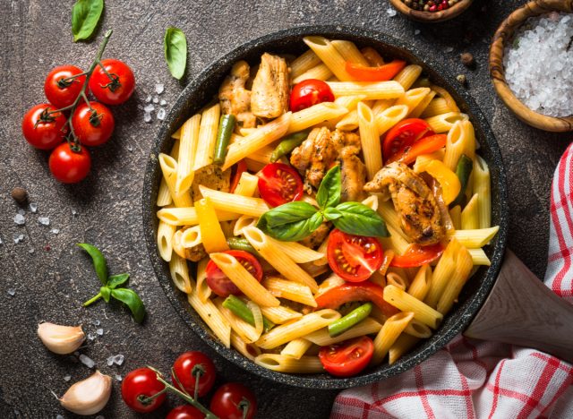 penne pasta with chicken, veggies, and tomatoes