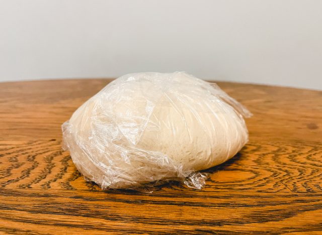 frozen pizza dough wrapped in cling film