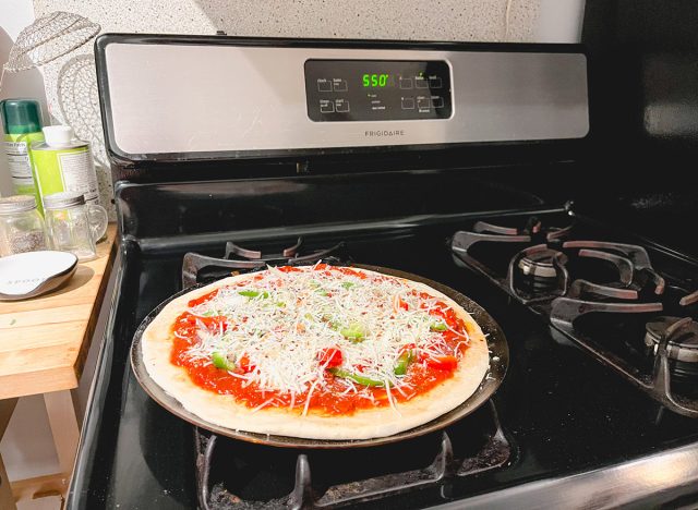 preparing pizza for sending to the oven at a temperature of 550 degrees