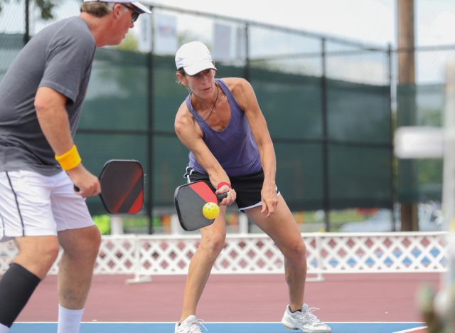 older couple playing a game of pickleball