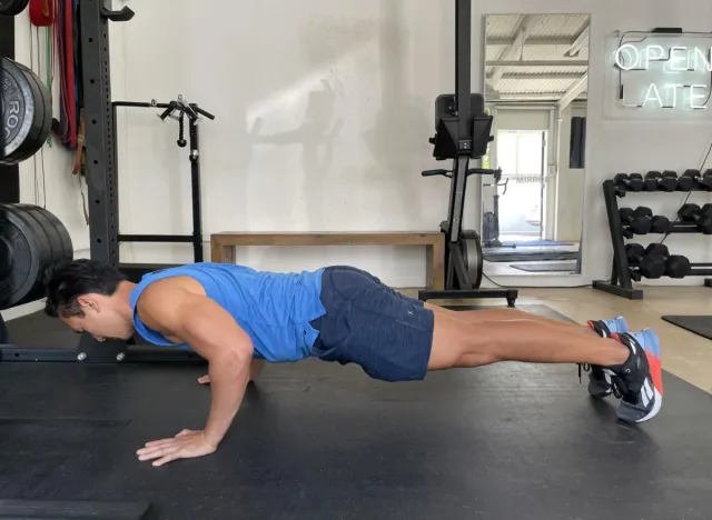 trainer demonstrating pushup to get rid of man boobs