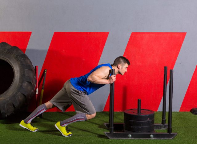 sled push exercise in gym on turf