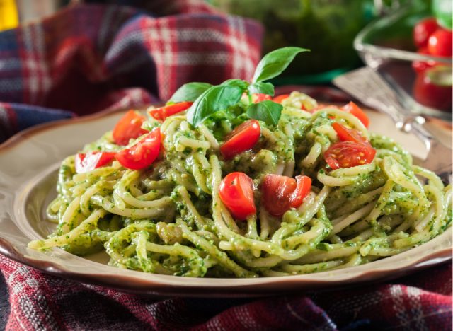 spaghetti with pesto sauce and sliced cherry tomatoes