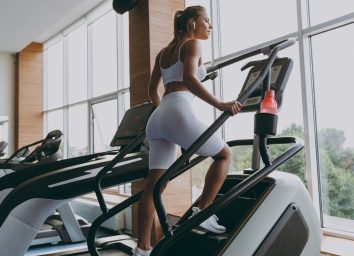 young woman doing stair climber to jumpstart weight loss