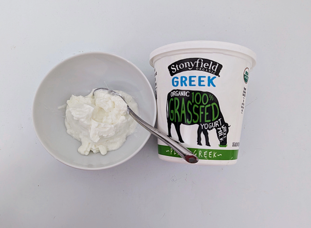 stonyfield greek yogurt in a bowl and a container. 