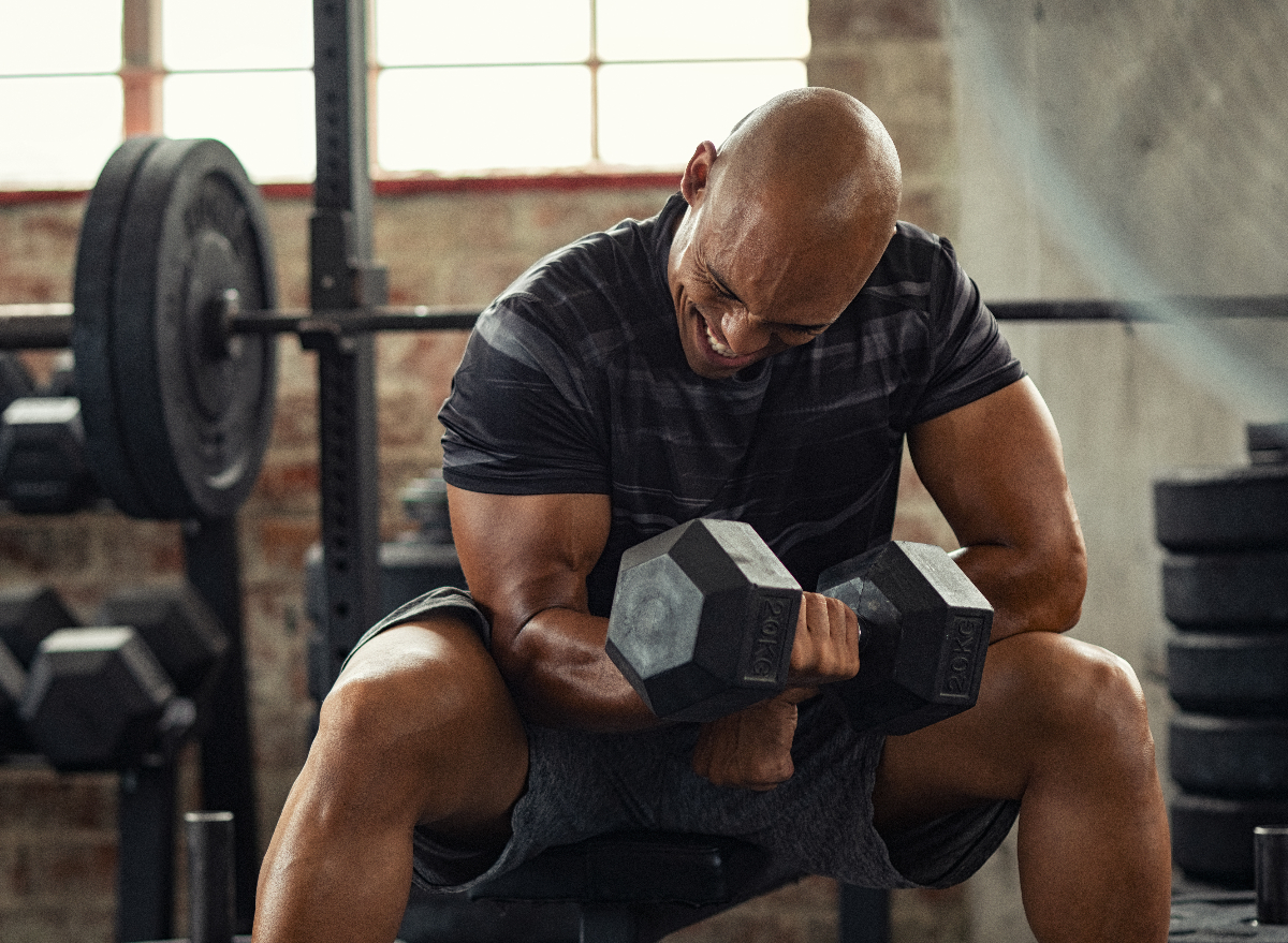 man in 40s using dumbbells to jumpstart weight loss goals