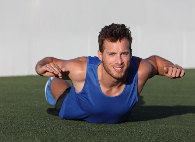 man doing superman stretch to warm up for cardio workout