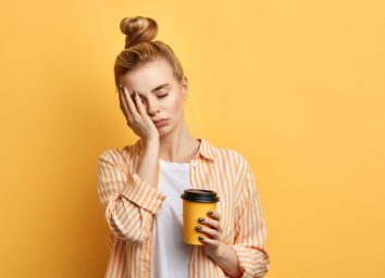 tired woman holding coffee
