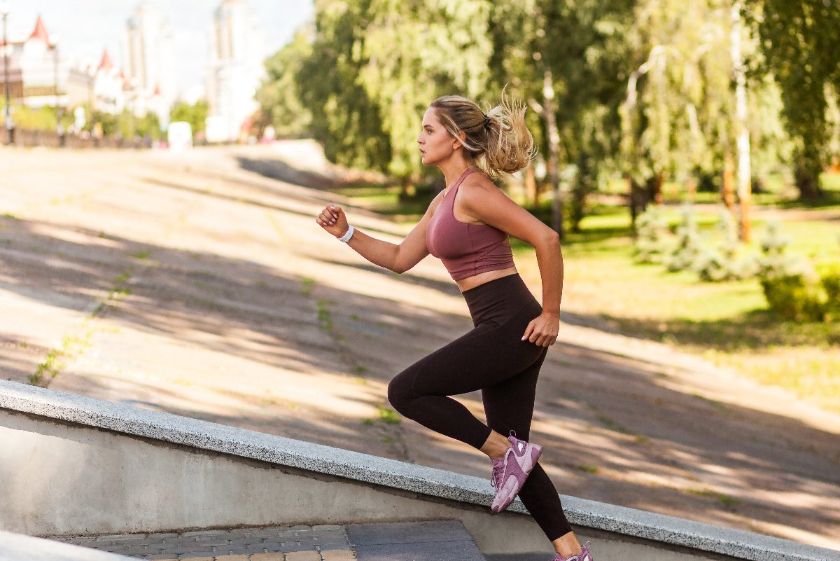 woman running up steps for cardio workout