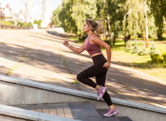 woman running up steps for cardio workout