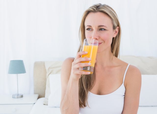 woman drinking orange juice