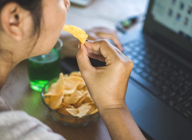 woman eating potato chips