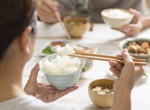 woman eating rice