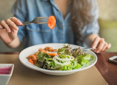 woman eating salad