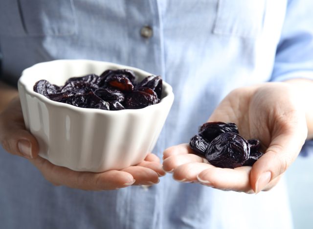 woman holding prunes