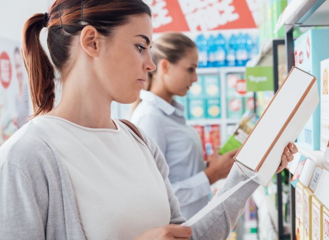 woman reading ingredients on box