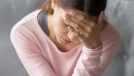woman dealing with severe headache or migraine at home