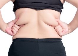 Woman squeezing back fat
